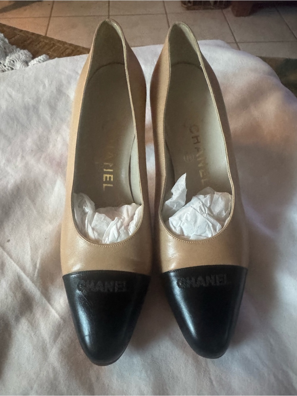 CHANEL Two-Tone Leather Cap-Toe Pumps in Beige and Black